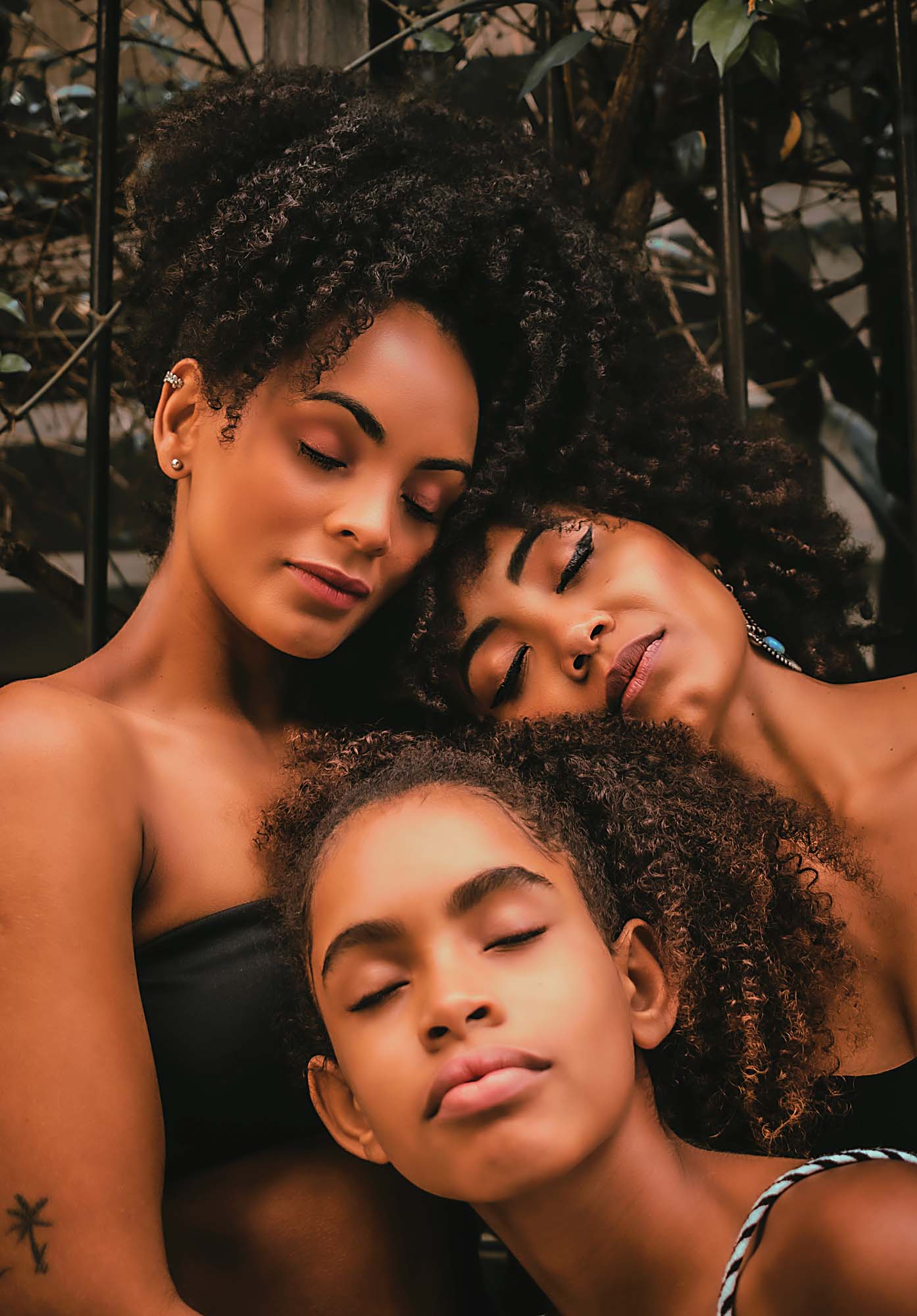 Three black women with their eyes closed